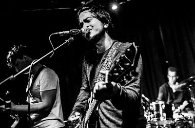 Black and white photo of Matthew Watt playing guitar